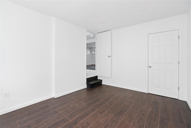 interior space with dark wood-style floors and baseboards