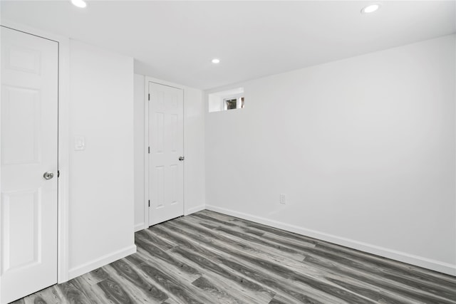 unfurnished bedroom with baseboards, wood finished floors, and recessed lighting