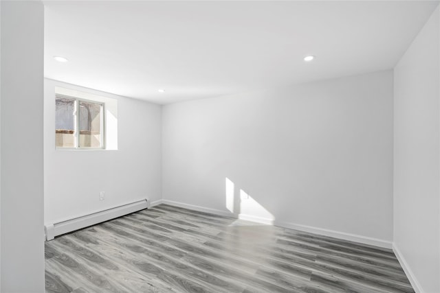 unfurnished room with recessed lighting, baseboards, baseboard heating, and wood finished floors