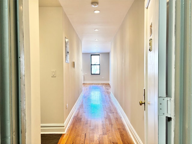 hallway with baseboards and wood finished floors