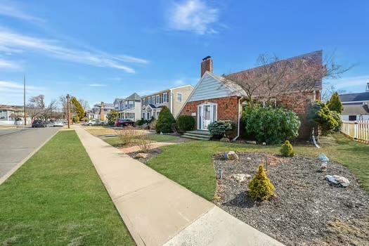 view of home's community with a yard, fence, and a residential view