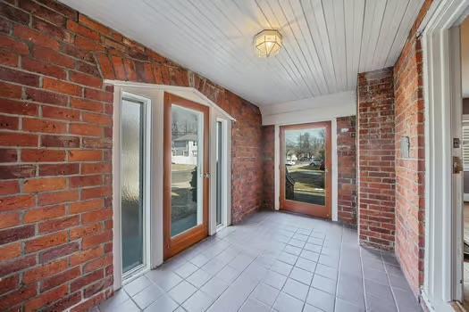 unfurnished sunroom featuring wood ceiling