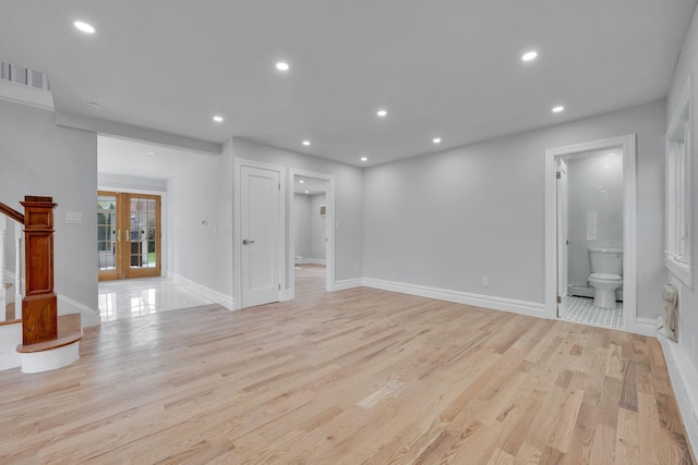 unfurnished living room with recessed lighting, baseboards, french doors, and light wood-type flooring