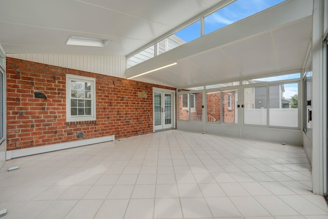 unfurnished sunroom with vaulted ceiling, french doors, brick wall, and a baseboard heating unit