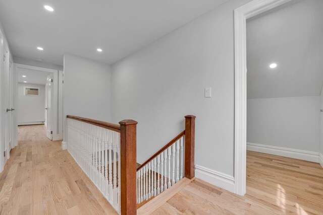 corridor with recessed lighting, an upstairs landing, light wood-style flooring, and baseboards