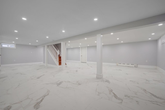 basement featuring recessed lighting, marble finish floor, baseboard heating, and stairway