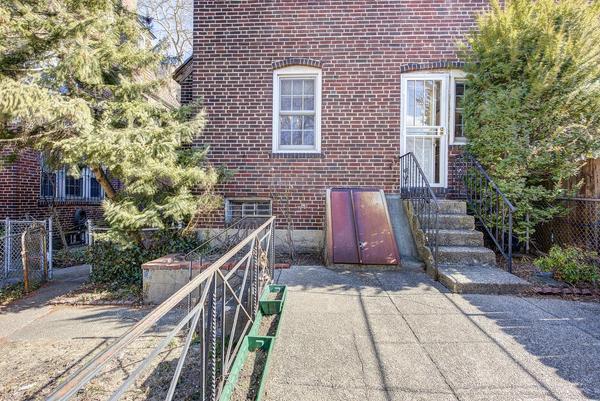 exterior space featuring brick siding and fence