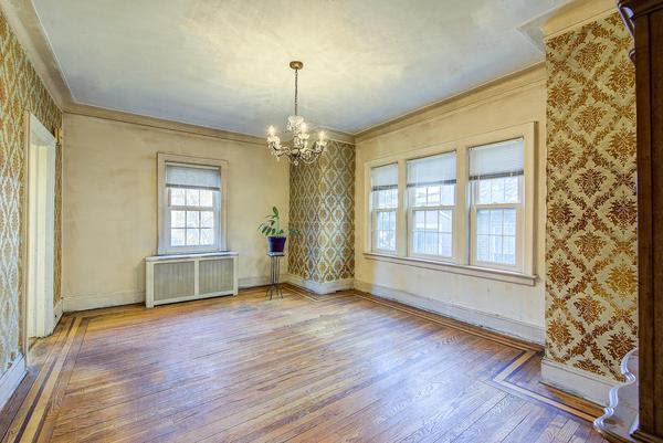 spare room featuring wallpapered walls, radiator heating unit, and ornamental molding