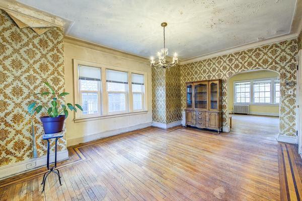 unfurnished dining area with baseboards, radiator, ornamental molding, and wallpapered walls