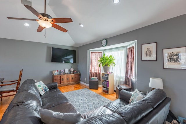 living area featuring light wood finished floors, baseboards, lofted ceiling, ceiling fan, and recessed lighting