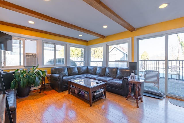 living area with plenty of natural light, light wood-style flooring, and beamed ceiling