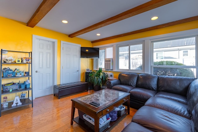 living area featuring light wood-type flooring, beamed ceiling, and recessed lighting