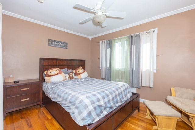 bedroom featuring crown molding, ceiling fan, and light wood-style floors