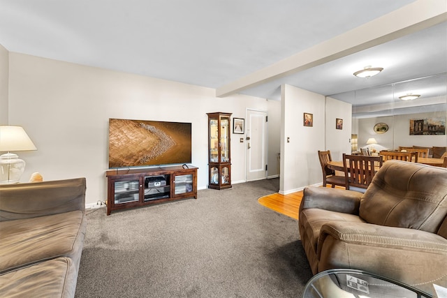 carpeted living area with baseboards and beamed ceiling