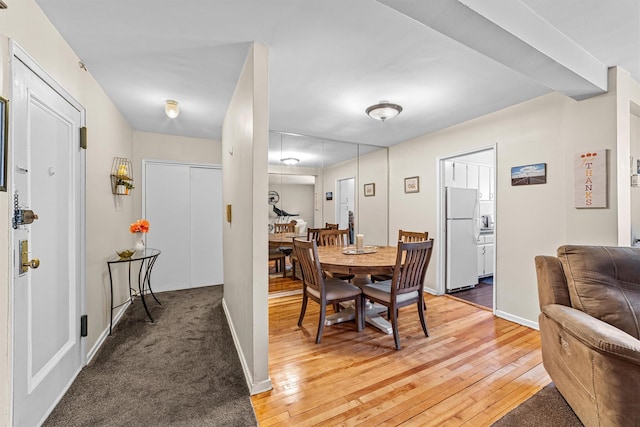 dining area with light wood-style flooring and baseboards