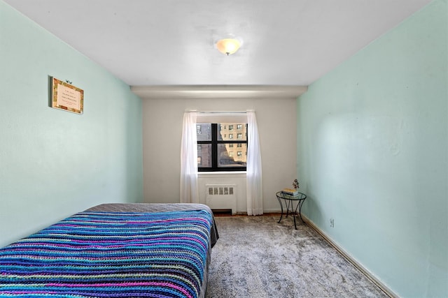 bedroom with carpet, radiator, and baseboards