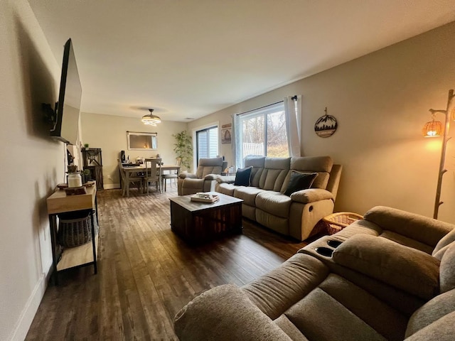 living room with dark wood finished floors and baseboards