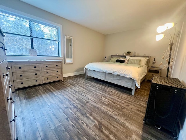 bedroom featuring baseboards and dark wood-type flooring