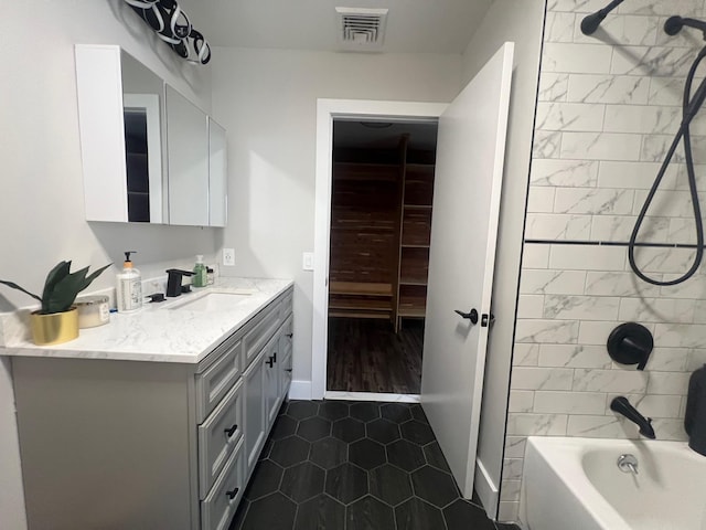 full bathroom with shower / bathtub combination, vanity, visible vents, and baseboards