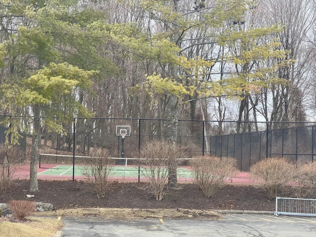 view of basketball court with community basketball court and fence