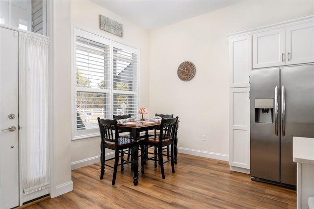 dining room featuring baseboards and wood finished floors