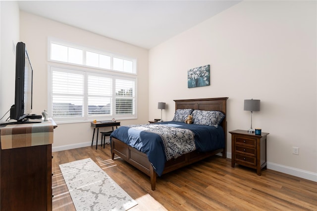 bedroom featuring baseboards and wood finished floors