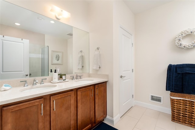 bathroom featuring double vanity, visible vents, a sink, and a walk in shower