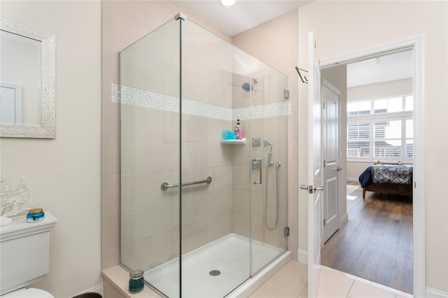 bathroom featuring a stall shower, ensuite bath, and toilet