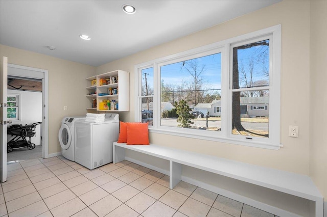 laundry area featuring washer and clothes dryer, laundry area, recessed lighting, and light tile patterned floors