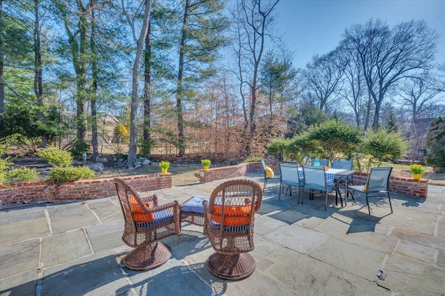 view of patio / terrace featuring outdoor dining space and an outdoor fire pit