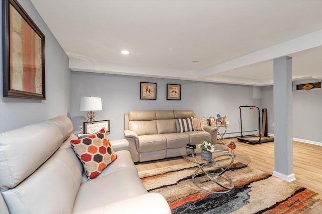 living area featuring a baseboard heating unit, recessed lighting, baseboards, and wood finished floors