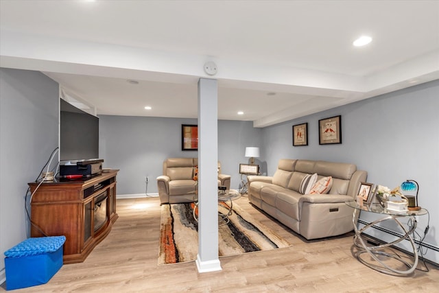 living area with baseboards, light wood-style flooring, and recessed lighting