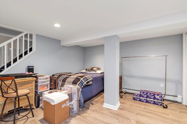 bedroom featuring a baseboard radiator, baseboards, light wood finished floors, and recessed lighting