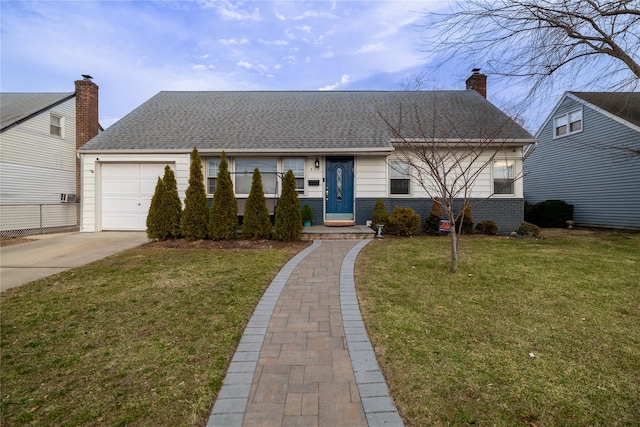 view of front of home with an attached garage, a chimney, a front lawn, and concrete driveway