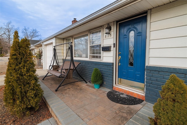 doorway to property with brick siding