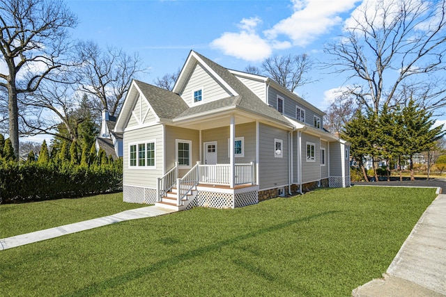 view of front of home with a porch, roof with shingles, and a front yard