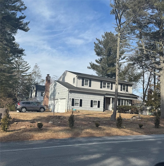 view of front of property with a chimney and an attached garage