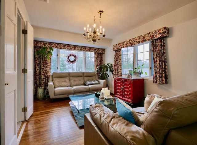 237 Berry Hill Rd, Syosset, NY 11791 - living room featuring wood finished floors and an inviting chandelier
