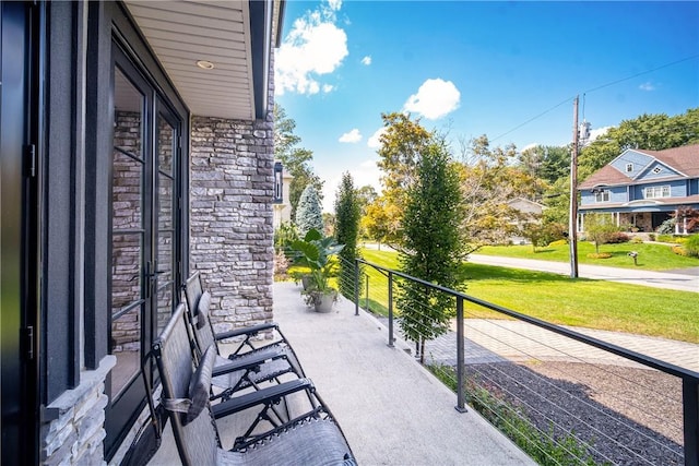 view of patio featuring a balcony