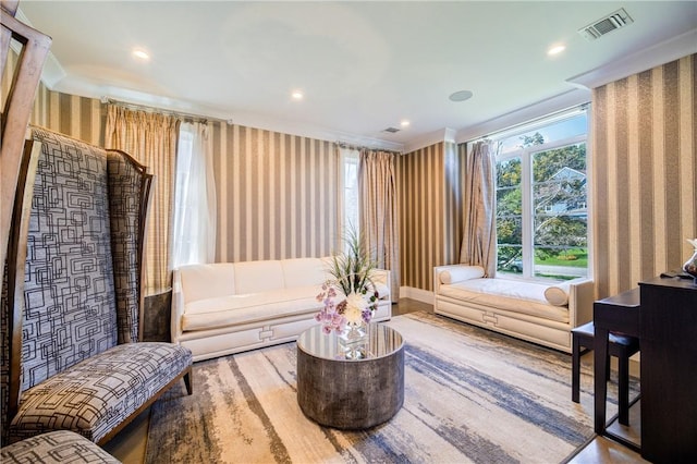 sitting room with recessed lighting, visible vents, crown molding, and wallpapered walls