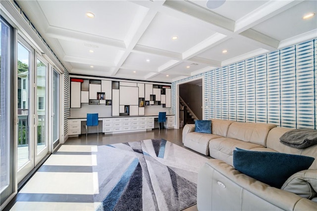 living area with stairway, built in study area, wood finished floors, coffered ceiling, and beamed ceiling