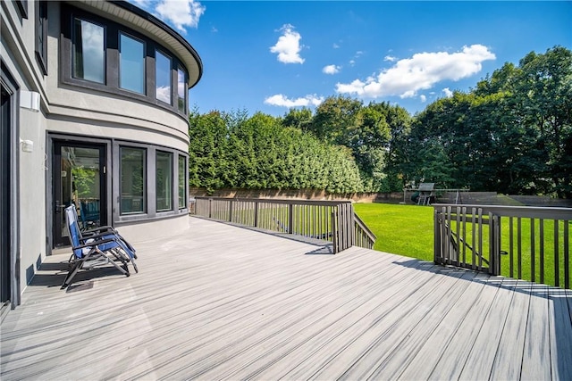 deck with a fenced backyard and a yard