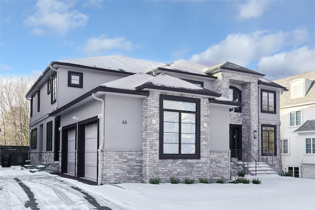 view of front facade with stone siding and stucco siding