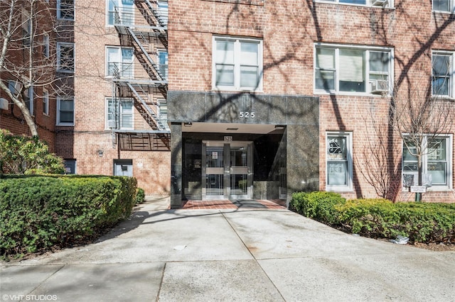 view of exterior entry with brick siding