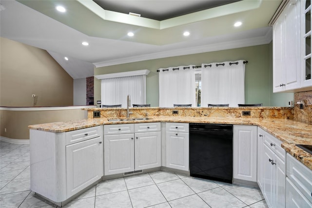 kitchen featuring a tray ceiling, white cabinets, a sink, and recessed lighting