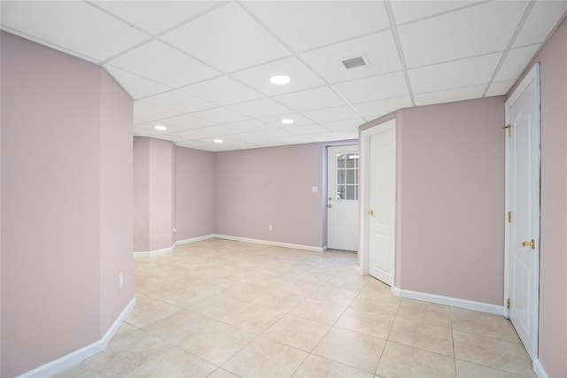 unfurnished room with recessed lighting, visible vents, light tile patterned flooring, a drop ceiling, and baseboards