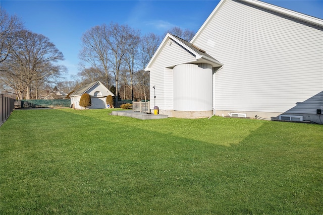 view of yard featuring a patio, an outdoor structure, and fence