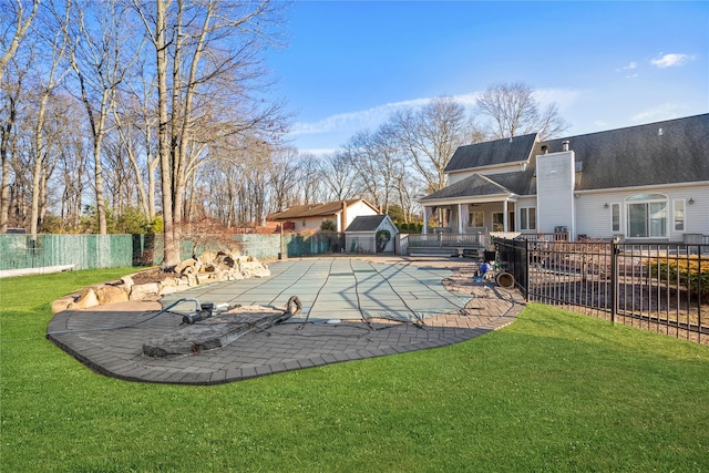 view of swimming pool featuring a yard, a patio area, a fenced backyard, and a fenced in pool