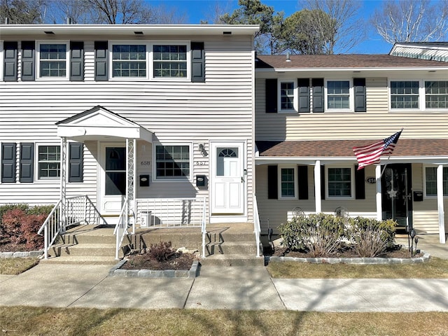 view of property featuring a shingled roof