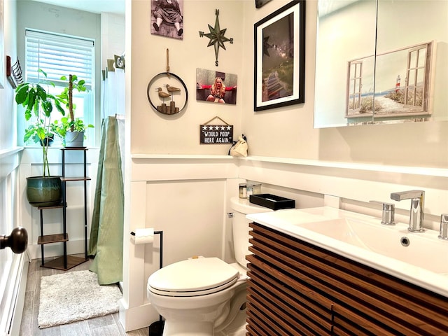 full bathroom with a shower, wood finished floors, vanity, and toilet